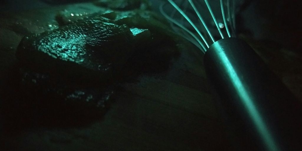 a whisk sitting on top of a wooden table