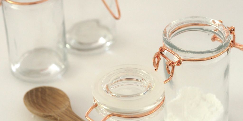 open glass jar near brown wooden spatula