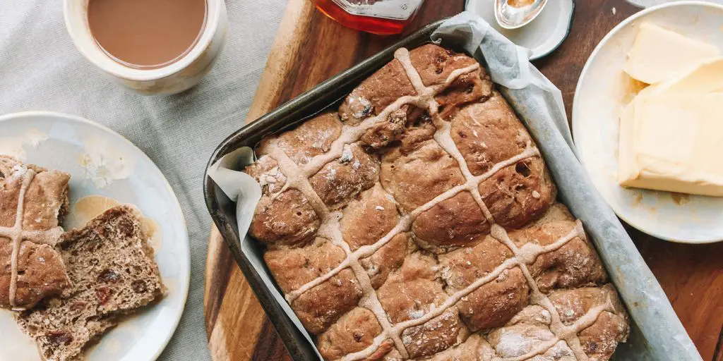 baked bread on pan on top of table beside butter on plate